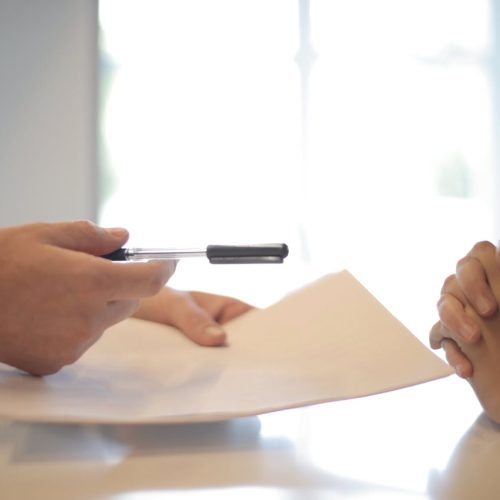 pexels-photo-3760067 Close-up of a contract signing with hands over documents. Professional business interaction.