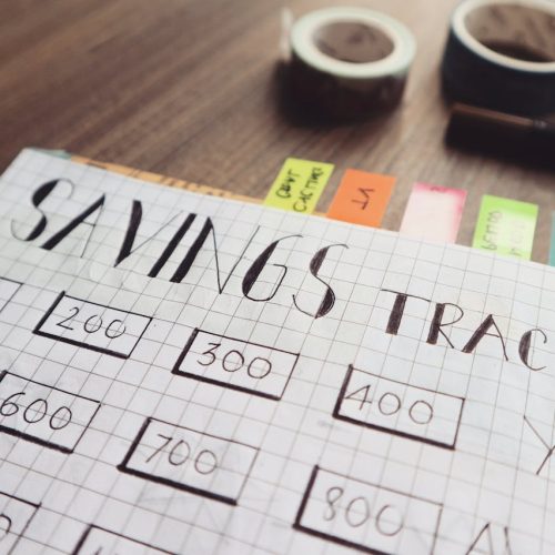 pexels-photo-732444 Close-up of a handmade savings tracker with colored tabs on a wooden table, ideal for financial planning visuals.